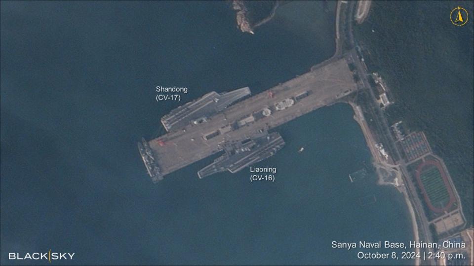 A satellite image shows China's two operational aircraft carriers docked at the same naval base.