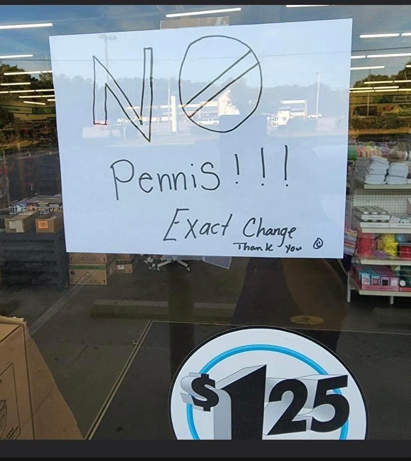 Sign on store window reads: "NO Pennies!!! Exact Change Thank You ?" with a crossed-out penny symbol