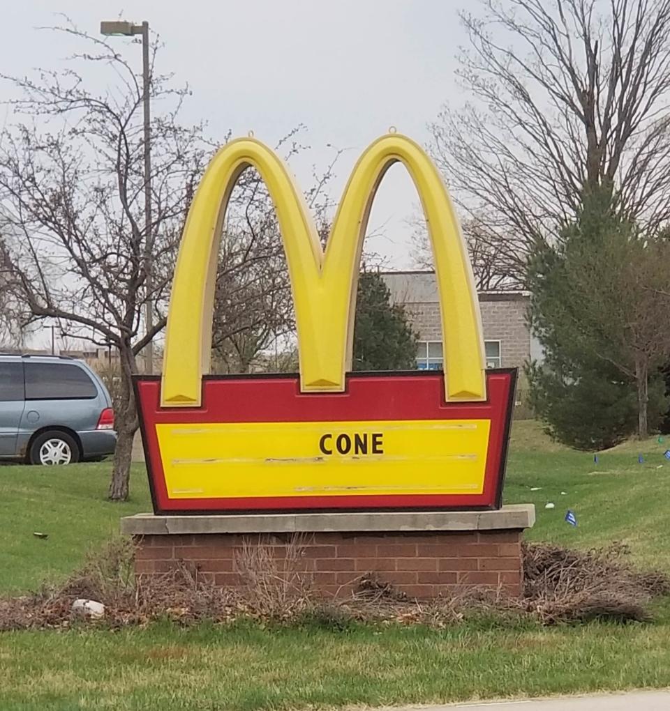 sign reading cone below a McDonald's logo