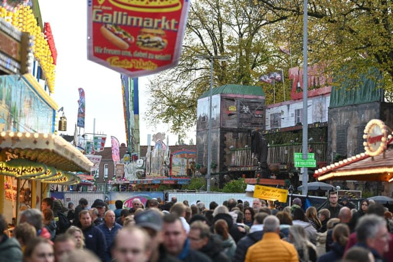 Emergency services set up a screen at the Gallimarkt. Five people were injured on Sunday when a ghost train caught fire at a bustling carnival in a town in north-eastern Germany, police said. Lars Penning/dpa