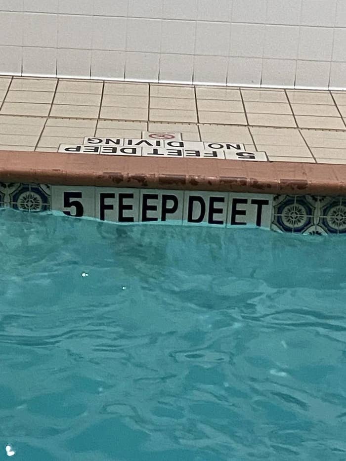 Sign at a pool reads "5 FEEP DEET" instead of "5 FEET DEEP."