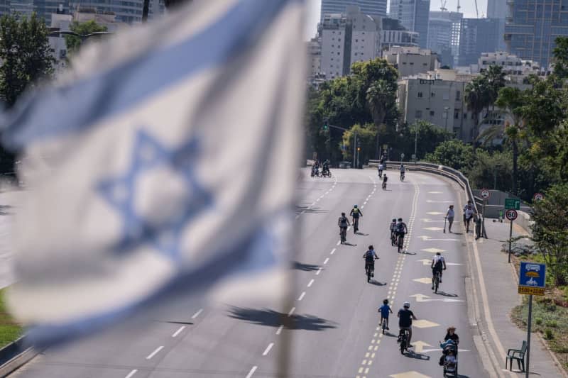 People ride their bicycles along an empty highway during a fast day of Jewish holiday of Yom Kippur. Ilia Yefimovich/dpa