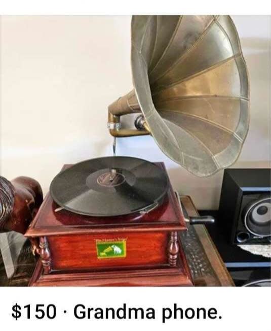 A vintage gramophone with a horn and turntable. Price tag below reads: "$150 · Grandma phone."