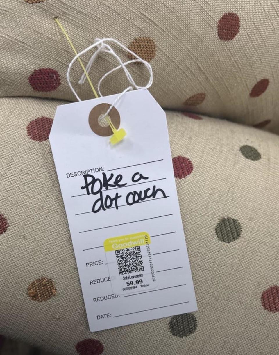 Price tag on a polka dot couch at Goodwill, labeled "poke a dot couch," priced at $59.99, reduced from $69.99