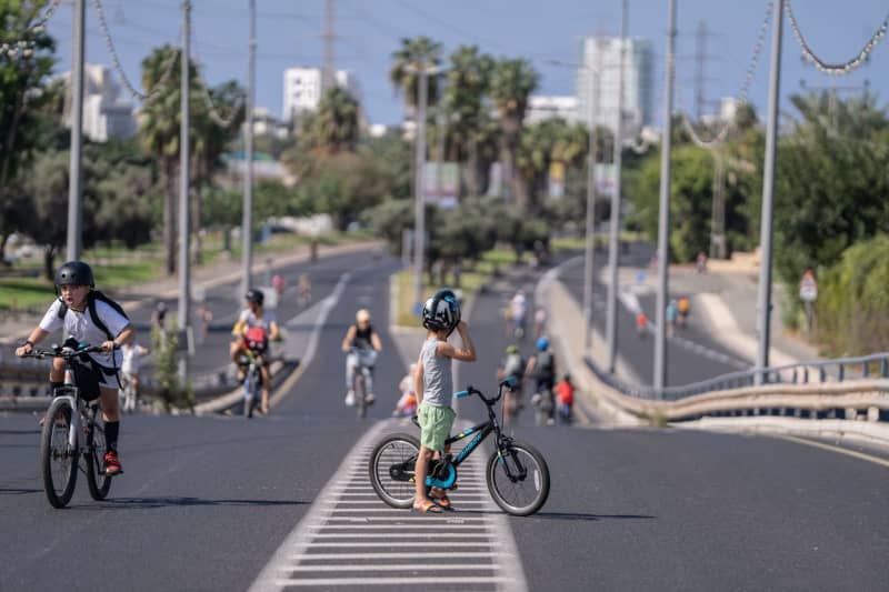 People ride their bicycles along an empty highway during a fast day of Jewish holiday of Yom Kippur. Ilia Yefimovich/dpa