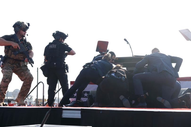 Republican presidential candidate Donald Trump is swarmed by Secret Service agents after shots were fired during a rally on July 13, 2024, in Butler, Pennsylvania.  / Credit: Getty Images