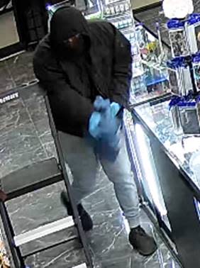 A security camera image shows a masked man carrying a blue bag wanted for stealing disposable vape devices during an armed robbery with two other men at the Kenworthy Tobacco and Vape store, 10765 Kenworthy St. in Northeast El Paso on Dec. 18, 2024.