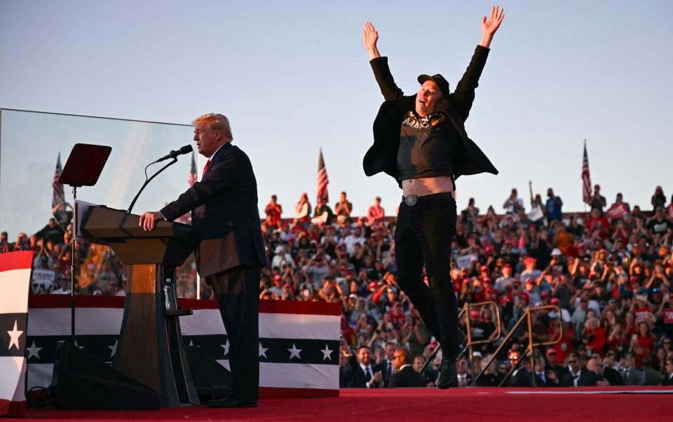 Elon Musk jumps behind Donald Trump during a rally in Butler, Pennsylvania