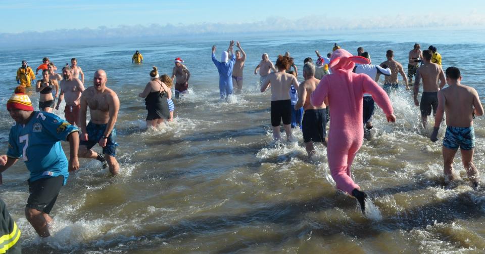 And they're off to become Polar Bears! About 600 to 800 people, or more, dash or gingerly stroll into chilly Lake Michigan on Jan. 1 off the Lakeside Park shore during the Jacksonport Polar Bear Club's annual Polar Bear Swim on New Year's Day.