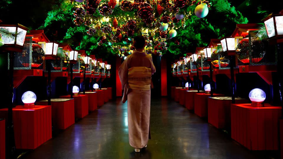 A visitor looks at a Christmas installation with goldfish and colorful lights at Tokyo's Art Aquarium Museum. - Kim Kyung-Hoon/Reuters/File