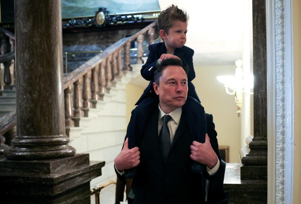 Elon Musk carries his son X-Æ-12 on his shoulders during a visit to the US Capitol