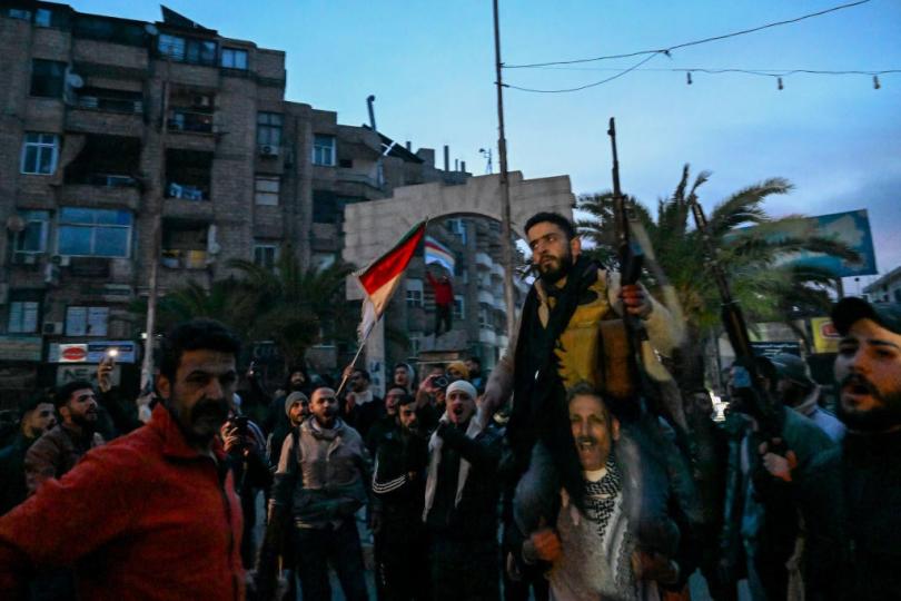 Residents gather on a street in the Damascus suburb of Jaramana on Dec. 8, 2024, after Syrian rebels said that President Bashar Assad had fled the country.  / Credit: LOUAI BESHARA/AFP via Getty Images