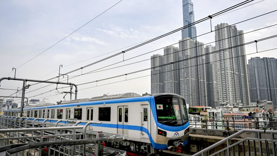 A train of the Line 1 of the HCMC Metro is seen passing by residential buildings in Ho Chi Minh City. - Nhac Nguyen/AFP/Getty Images