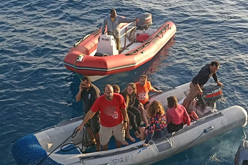 Survivors on two dinghies. There are eight people on one vessel - it is not clear how many are survivors and how many are rescuers. There is one man in the other dinghy. 