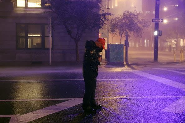 TAMPA, FLORIDA - OCTOBER 09: A television reporter stands on a downtown street as Hurricane Milton makes landfall on October 09, 2024, in Tampa, Florida. Milton, coming on the heels of the destructive Helene, hit as a category 3 storm with winds of over 100 mph, though avoiding the projected direct hit on Tampa. Instead, the storm, which earlier had reportedly spawned tornadoes, landed about 70 miles south of Tampa near Siesta Key, a strip of white-sand beaches that's home to 5,500 people, according to published reports.  (Photo by Spencer Platt/Getty Images)