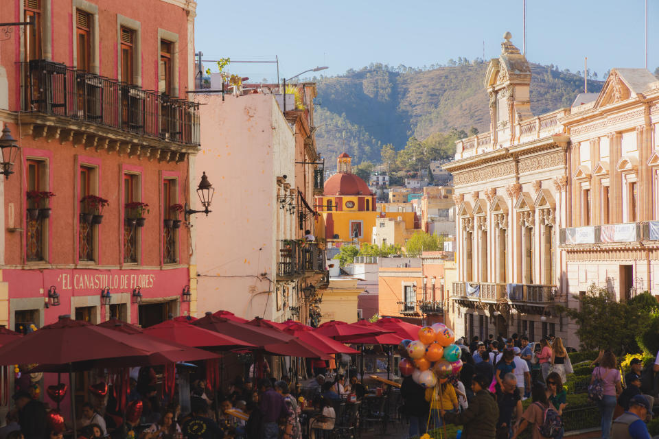 Guanajuato, Mexico - February 4, 2024: A vibrant and bustling scene at Plaza de la Paz in Guanajuato, Mexico, featuring colorful Spanish colonial architecture, outdoor cafes, and locals mingling with tourists.