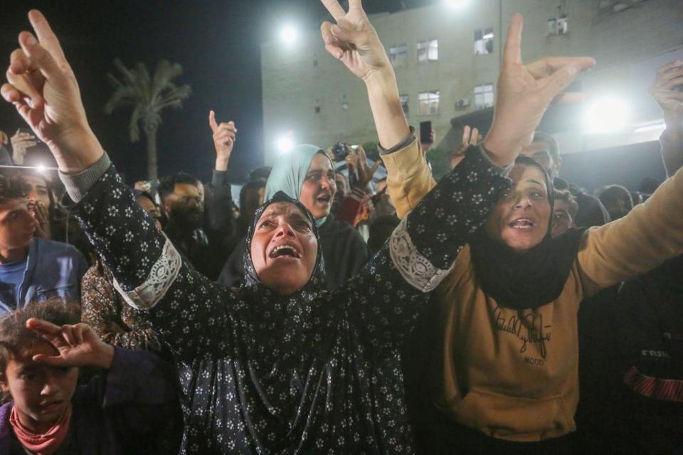 Palestinians celebrate the announcement of ceasefire deal in Deir al-Balah, central Gaza.