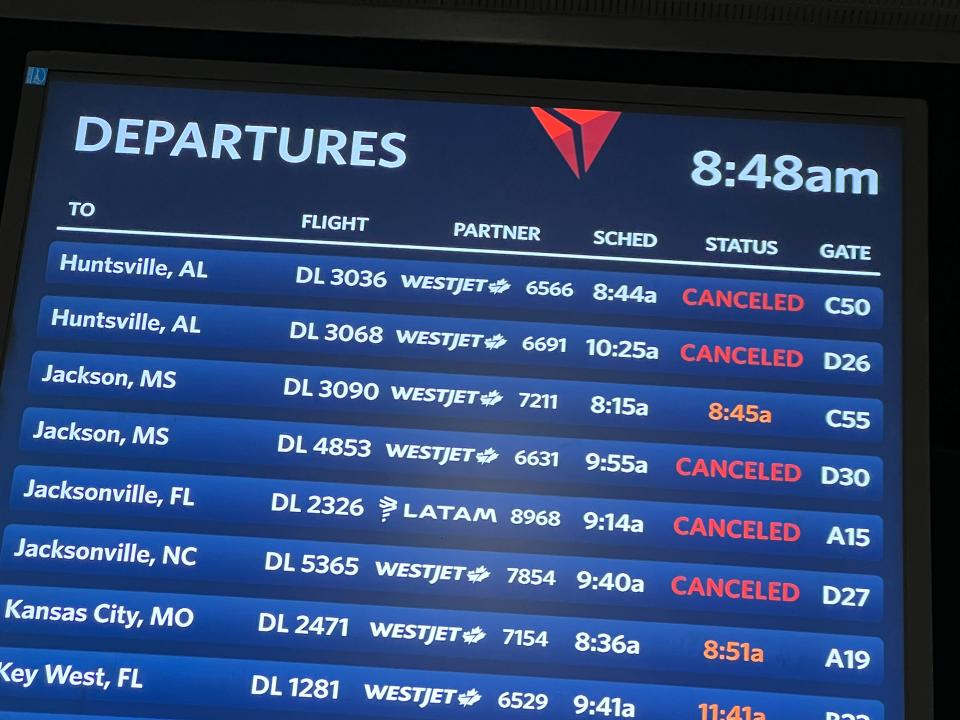 A departure board shows canceled flights as snow blankets Hartsfield-Jackson Atlanta International Airport as a winter storm moves into the area on Jan. 10, 2025.