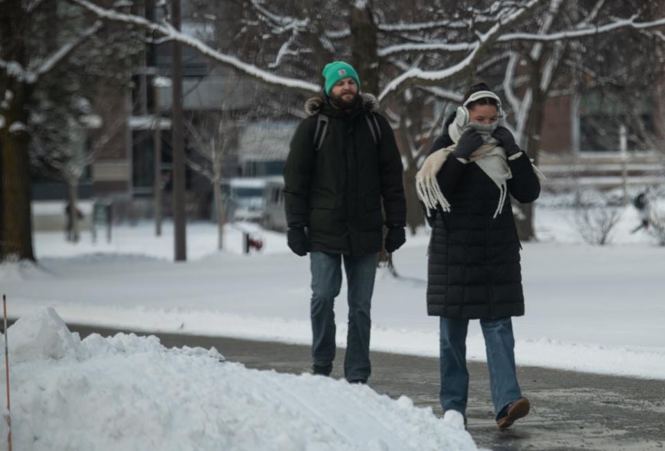 People brave the cold on the campus of Michigan State University, Tuesday, Jan. 21, 2025.