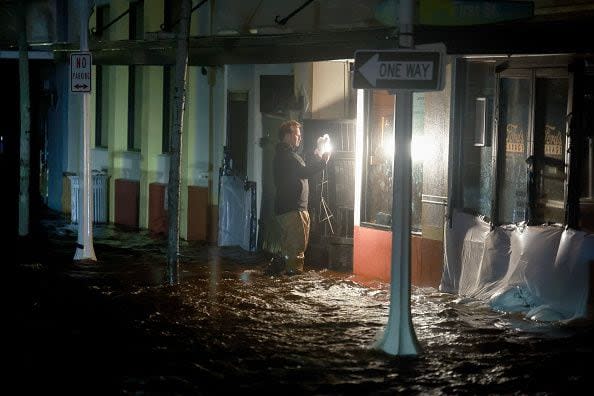 FORT MYERS BEACH, FLORIDA - OCTOBER 09: A person walks through surge waters after Hurricane Milton made landfall in the Sarasota area on October 09, 2024, in Fort Myers, Florida. Milton, coming on the heels of the destructive Helene, hit as a category 3 storm with winds of over 100 mph, though veering south of the projected direct hit on Tampa. Instead, the storm, which earlier had reportedly spawned tornadoes, landed about 70 miles south of Tampa near Siesta Key, a strip of white-sand beaches that's home to 5,500 people, according to published reports.. (Photo by Joe Raedle/Getty Images)