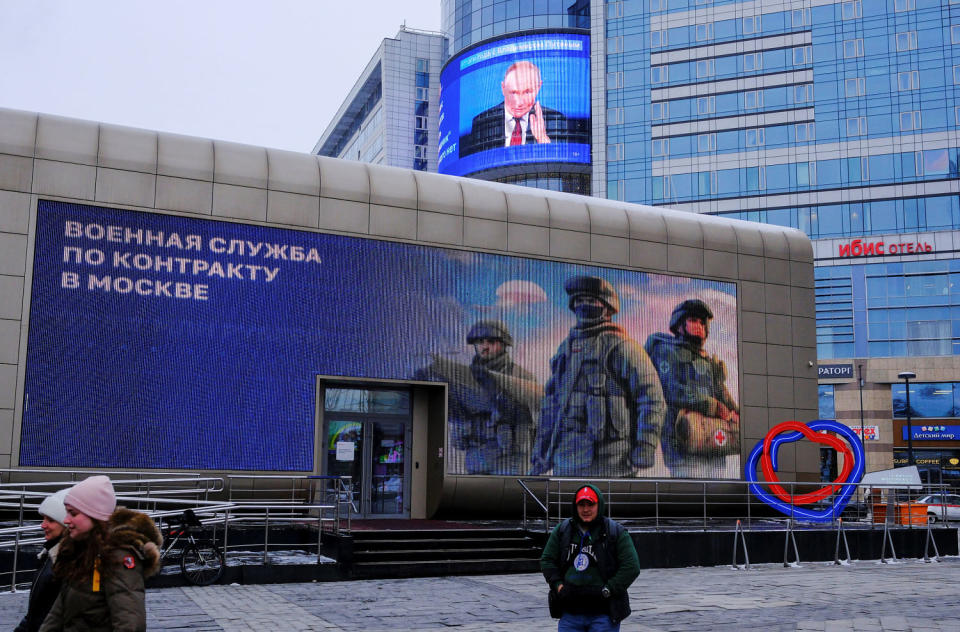 A screen shows a quote from Russian President Putin's annual press conference in Moscow (Shamil Zhumatov / REUTERS)