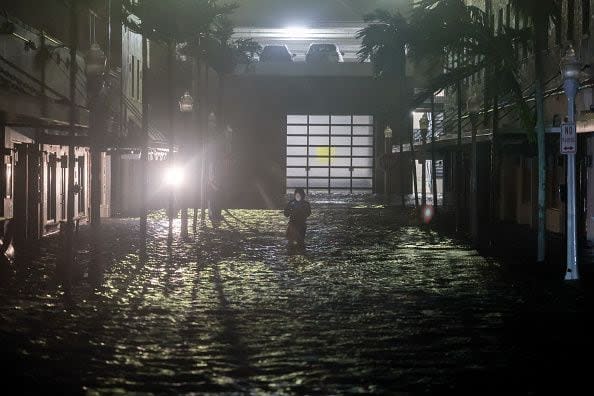 FORT MYERS BEACH, FLORIDA - OCTOBER 09: A person walks through surge waters after Hurricane Milton made landfall in the Sarasota area on October 09, 2024, in Fort Myers, Florida. Milton, coming on the heels of the destructive Helene, hit as a category 3 storm with winds of over 100 mph, though veering south of the projected direct hit on Tampa. Instead, the storm, which earlier had reportedly spawned tornadoes, landed about 70 miles south of Tampa near Siesta Key, a strip of white-sand beaches that's home to 5,500 people, according to published reports.. (Photo by Joe Raedle/Getty Images)