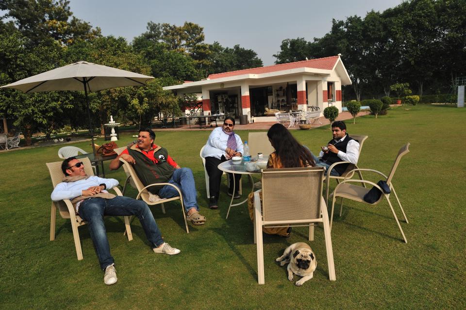 Socialites relax outdoors on a patio set