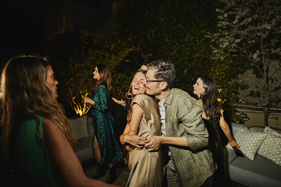 People joyfully dancing and socializing at an outdoor night gathering