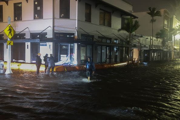 FORT MYERS BEACH, FLORIDA - OCTOBER 09: Members of the media work in flooded streets after Hurricane Milton made landfall in the Sarasota area on October 09, 2024, in Fort Myers, Florida. Milton, coming on the heels of the destructive Helene, hit as a category 3 storm with winds of over 100 mph, though veering south of the projected direct hit on Tampa. Instead, the storm, which earlier had reportedly spawned tornadoes, landed about 70 miles south of Tampa near Siesta Key, a strip of white-sand beaches that's home to 5,500 people, according to published reports.. (Photo by Joe Raedle/Getty Images)