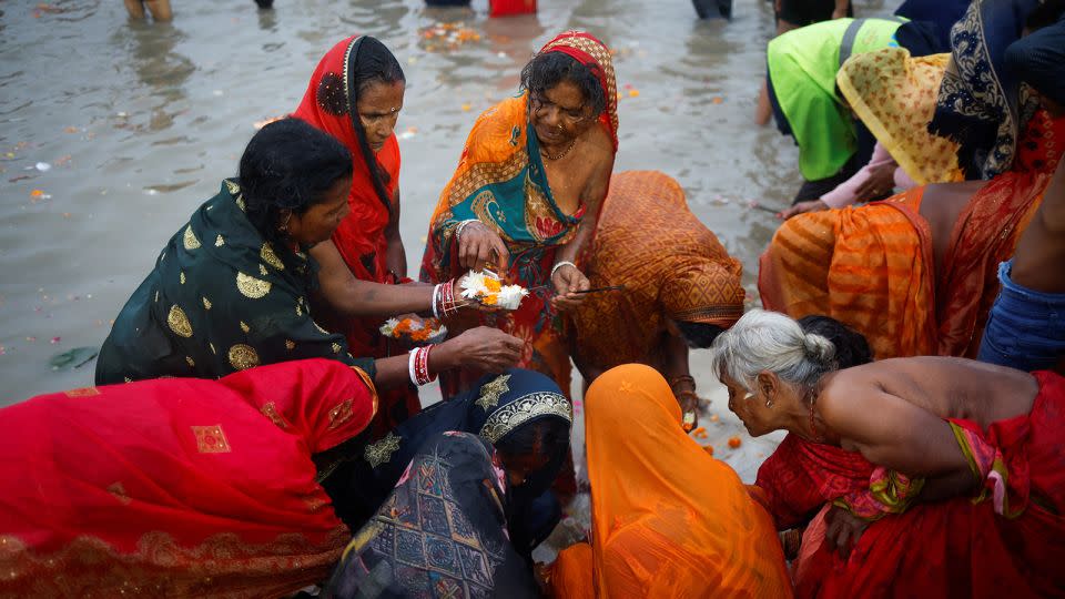 People offer prayers at Sangam, the confluence of the Ganges, Yamuna and Saraswati rivers, during the Maha Kumbh Mela Festival, in Prayagraj, India, on January 13, 2025. - Adnan Abidi/Reuters