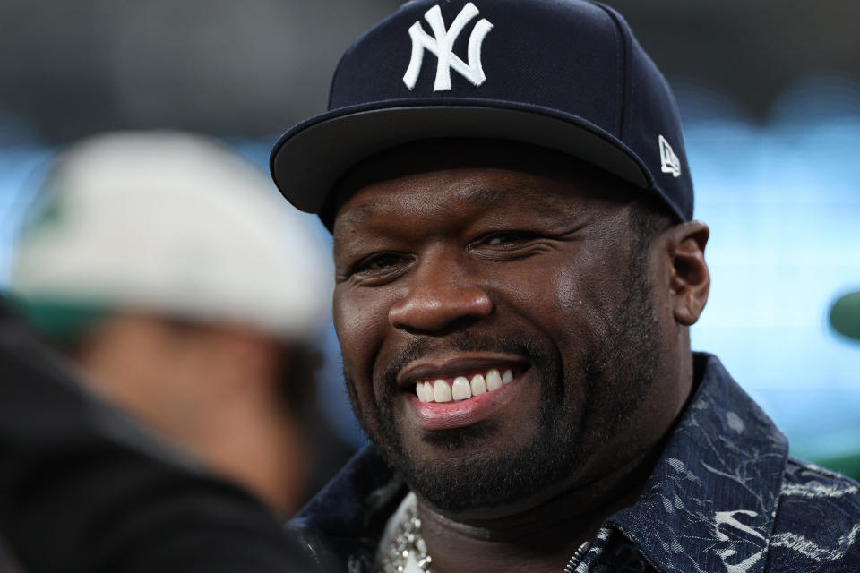 Man in a New York Yankees cap smiling at an event