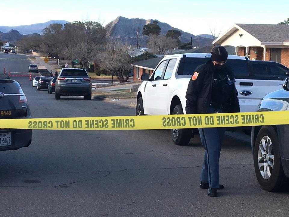 An El Paso police officer walks up the street from where homicide detectives  on Sunday morning investigate a fatal stabbing at a West Side home in the 5800 block of Beaumont Place.