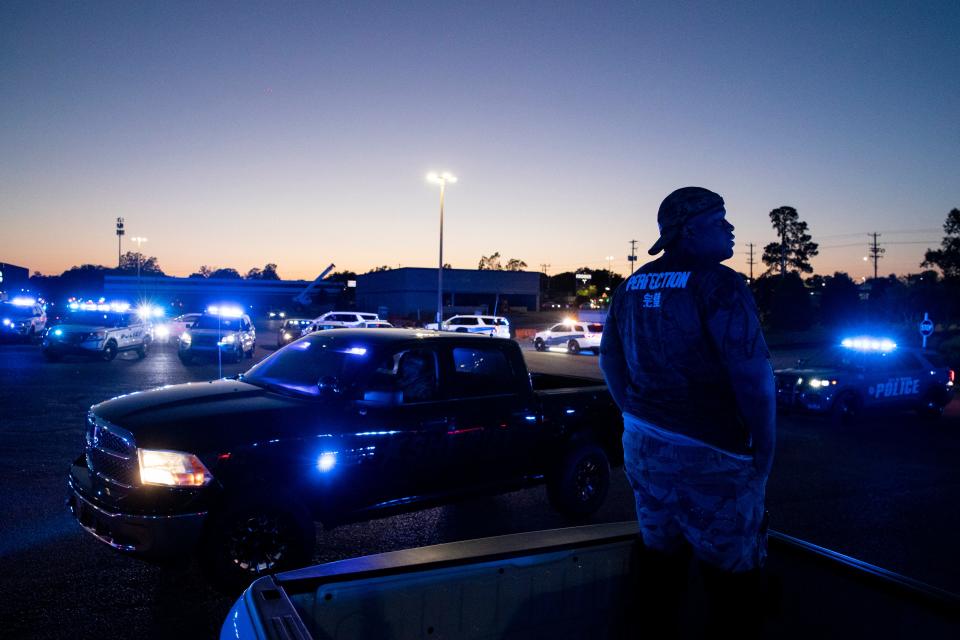 Gerald Stubbs, an off-duty Memphis Police Department officer, watches as MPD officers, as well as officers and deputies from nearby departments, take part in a Sea of Blue, a procession of police vehicles with their lights flashing, to honor slain MPD officer Joseph McKinney on Sunday, April 21, 2024. McKinney was killed in a shootout April 12 while responding to a “suspicious vehicle” call.