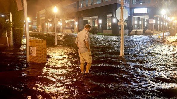 FORT MYERS BEACH, FLORIDA - OCTOBER 09: Brandon Marlow walks through surge waters flooding the street after Hurricane Milton came ashore in the Sarasota area on October 09, 2024, in Fort Myers, Florida. People are waiting to assess the damage after the Cat 3 hurricane came ashore. (Photo by Joe Raedle/Getty Images)