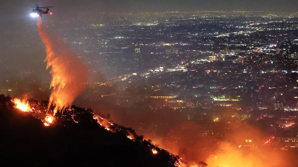 Image: Powerful Winds Fuel Multiple Fires Across Los Angeles Area firefighting helicopter (Mario Tama / Getty Images)