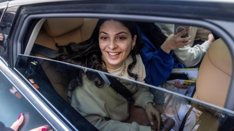 Daniella Gilboa seen smiling through the open window of a car where she sits in the back seat as she is welcomed home to Israel on 5/2/2025