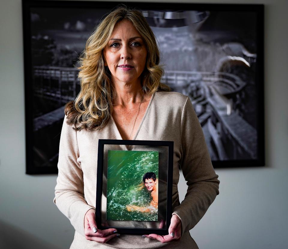 Laurie Martin-Giordano with a photo of her son, Zach, in Fort Myers, Florida, on Monday, Dec. 30, 2024. After her son died from a heat-related illness during football practice in 2017, she worked with lawmakers to introduce legislation that requires heat illness training and life-saving equipment for every Florida High School Athletic Association school. She founded the Zach Martin Memorial Foundation, which provides education, awareness, and prevention equipment for exertional heat illnesses to athletes, coaches, and parents.