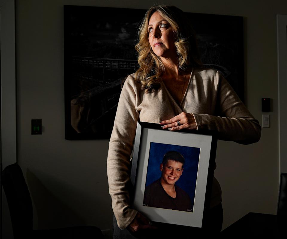 Laurie Martin-Giordano with a photo of her son, Zach, in Fort Myers, Florida, on Monday, Dec. 30, 2024. After her son died from a heat-related illness during football practice in 2017, she worked with lawmakers to introduce legislation that requires heat illness training and life-saving equipment for every Florida High School Athletic Association school. She founded the Zach Martin Memorial Foundation, which provides education, awareness, and prevention equipment for exertional heat illnesses to athletes, coaches, and parents.