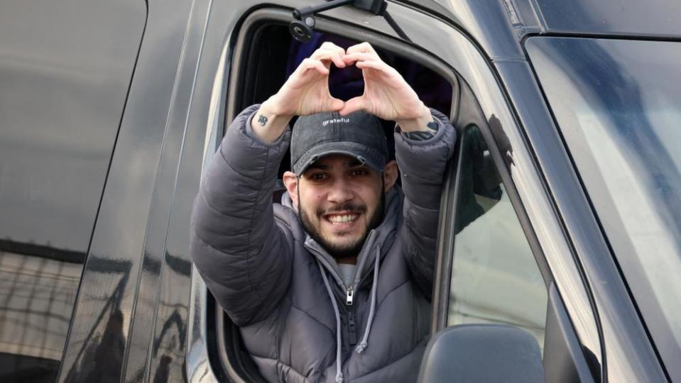 Image shows Eliya Cohen, a hostage who was held in Gaza since October 7, 2023, putting his hands into the shape of a love heart as he was released from captivity in Petah Tikva, Israel, on 22 February, 2025
