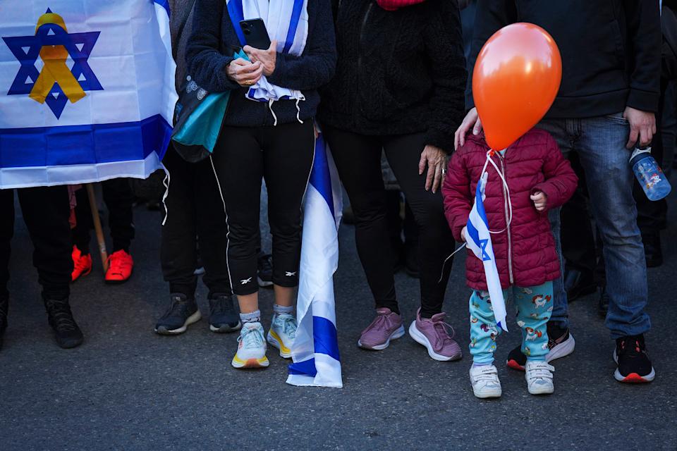 Mourners attend the funeral procession of slain hostages Shiri Bibas and her two children, Ariel and Kfir, in Rishon Lezion, Israel, Feb. 26, 2025. (Ariel Schalit / AP)