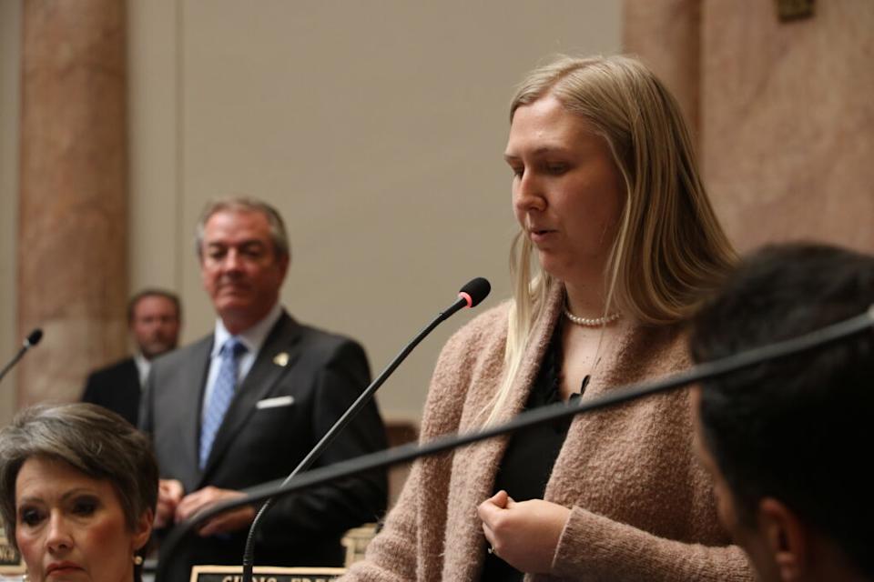 Roarx speaks in the foreground. Osborne listens in the background.