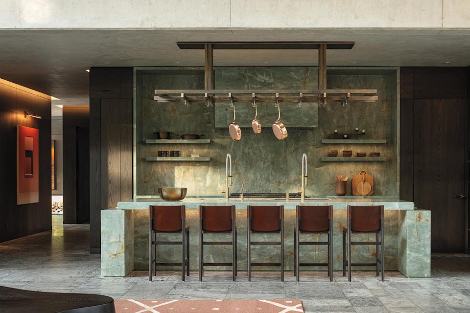 With custom millwork and striking emerald-quartzite features, the kitchen was meant to feel more sculptural than utilitarian.