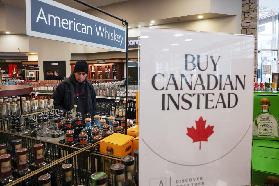 Empty shelves remain with signs ''Buy Canadian Instead'' after the top five U.S. liquor brands were removed from sale at a B.C. Liquor Store, in Vancouver (Chris Helgren / Reuters)