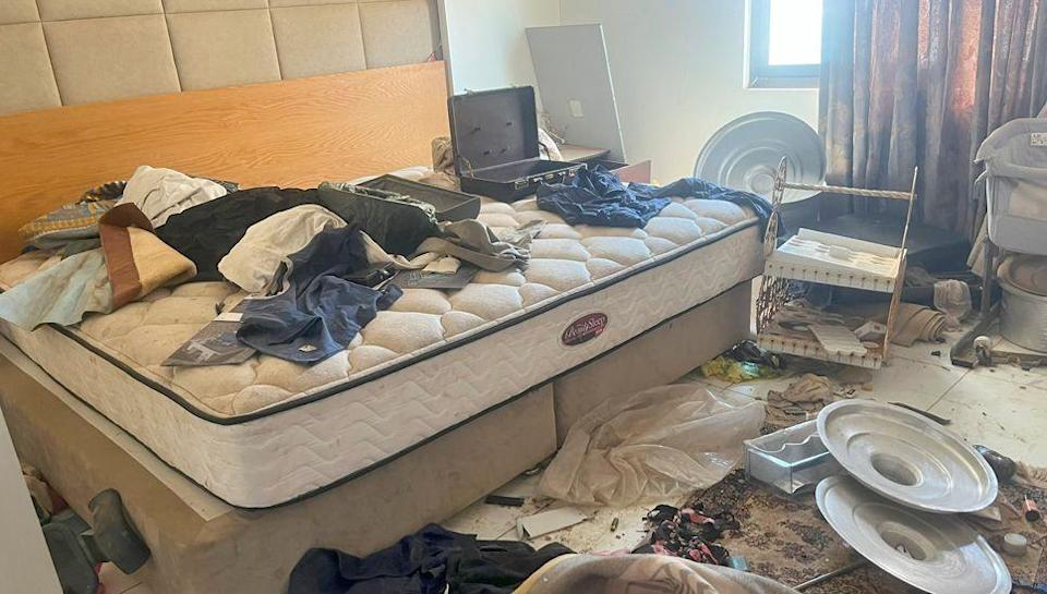 A room in Abdel Rahim Hamdan Dagalo's house in the upmarket Khartoum suburb of Karfuri  - showing clothes and a empty brief case on a bare mattress with pans and other things littered all over the floor.