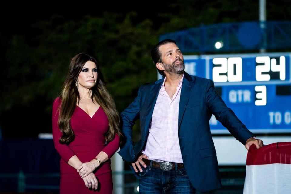 Kimberly Guilfoyle and Donald Trump Jr. watch Donald Trump speak at a Trump rally in Florida.