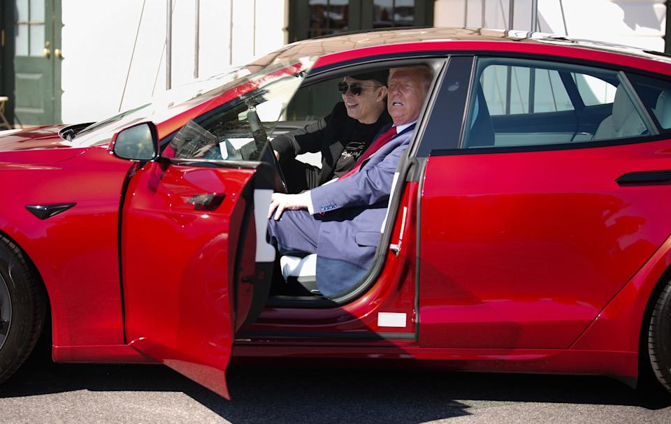 Musk and Trump inside a red Tesla model S