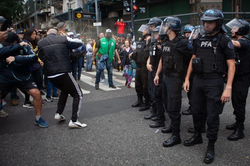 Police officers clash with protesters during a demonstration by soccer fans and retirees demanding higher pensions and opposing austerity measures implemented by Javier Milei's government in Buenos Aires. Paula Acunzo/ZUMA Press Wire/dpa