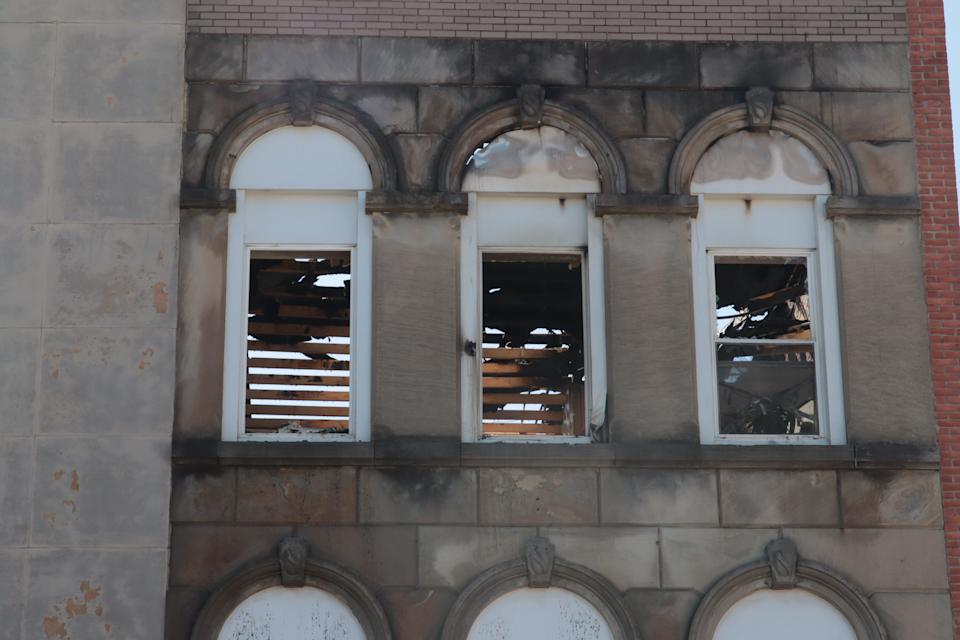 Fire damage to the roof can be seen Monday, March 17, 2025, through the third-floor windows of 123 W. Maumee St. in downtown Adrian. This building along with the buildings at 117, 119 and 121 W. Maumee St. were damaged by fire Saturday, March 15, 2025.