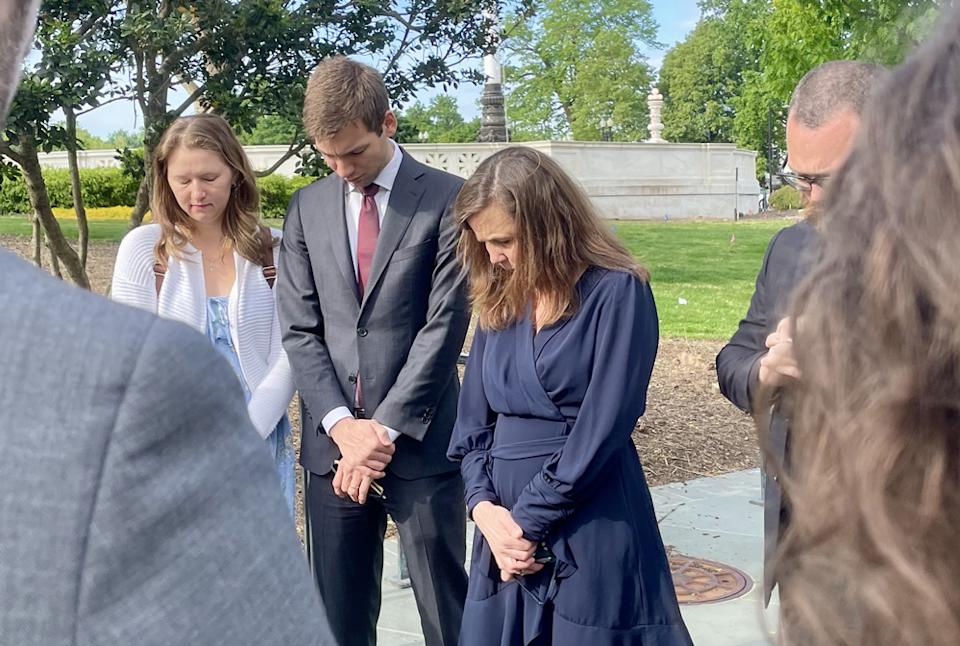 Nicole Stelle Garnett, a Notre Dame University law professor, prayed with students before entering the courtroom. Garnett crafted the legal argument that charters are private and can be religious. (Linda Jacobson/The 74)