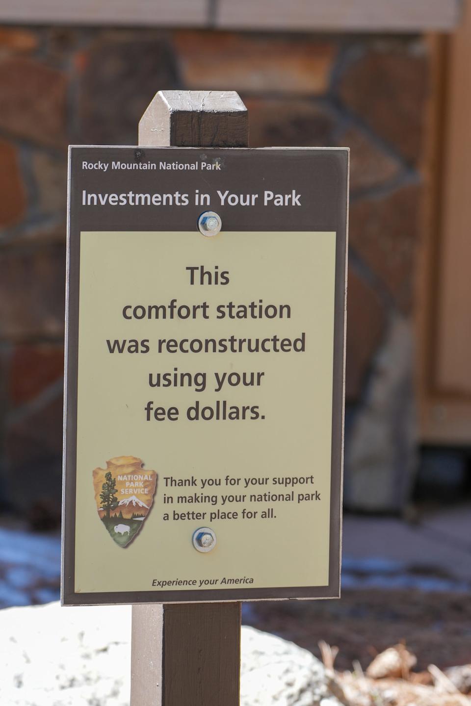 A sign tells visitors that restrooms at a Rocky Mountain National Park campground were being improved with money from entrance fees.